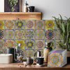 A close-up of colorful, patterned self-adhesive tile wall stickers displayed on a wooden surface.