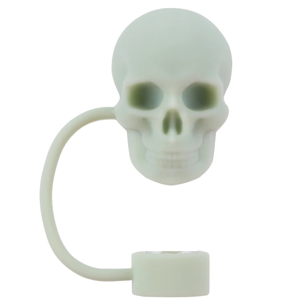 A white silicone straw cover shaped like a skull with a flexible loop and a flat base.