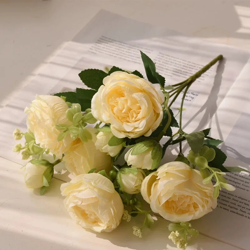 A bouquet of pale yellow and cream silk peony roses for decoration.