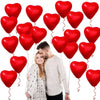 A couple is holding a large red heart-shaped latex balloon, surrounded by smaller red heart balloons.
