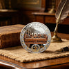 A commemorative coin set featuring the Last Supper scene and a cross design resting on a wooden surface.