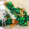 A lush green balloon arrangement featuring jungle foliage and a lion statue for party decor