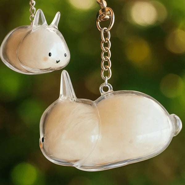 Clear glass rabbit charm keychain hanging from a silver chain