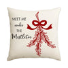 A cream-colored cushion cover featuring a red bow and mistletoe wreath design.