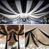 Elegant black sheer chiffon curtains draped across a venue for a wedding or event.