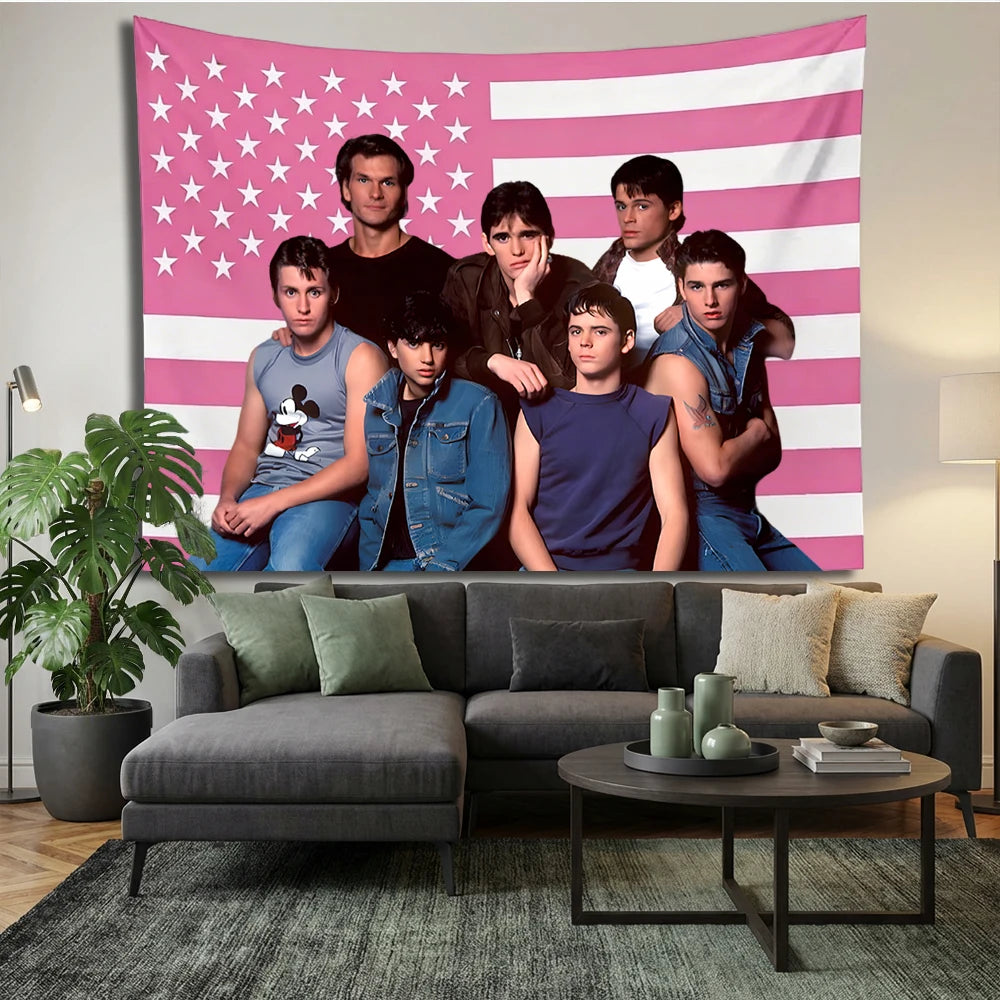 A group of seven young men posing in front of a pink and white striped American flag tapestry.