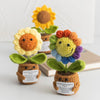 Handmade crochet sunflower desk companion with a smiling face in yellow and orange hues.