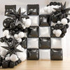 A wall display of black and white square foil balloons and star-shaped decorations for celebrations