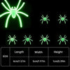 Glow-in-the-dark spider web Halloween decor featuring fake spiders with specified dimensions.