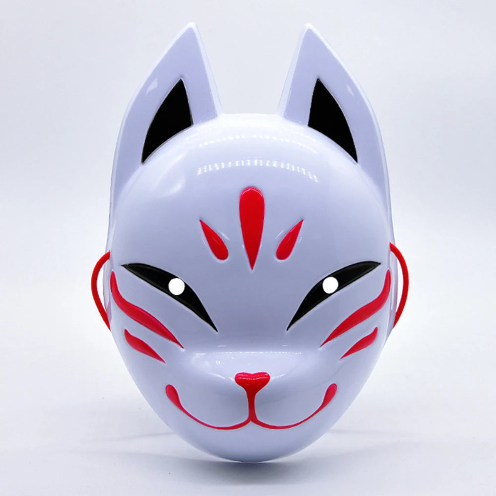 A white fox face mask with black eyes and red markings, designed for Halloween or costume parties.