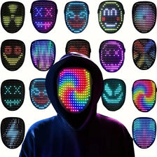 A person wearing a black hoodie is positioned in front of a grid of various glowing LED masks, including a central swirling m