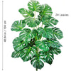 A lush green artificial Monstera plant with 24 silk leaves used for home and office decor.