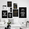A collection of black and gold motivational quote canvas wall art prints displayed on a white wall above a white sofa.