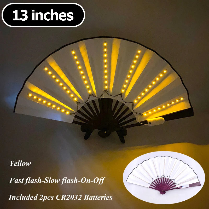 A yellow multi-mode LED party fan with a pleated design illuminated by bright lights.