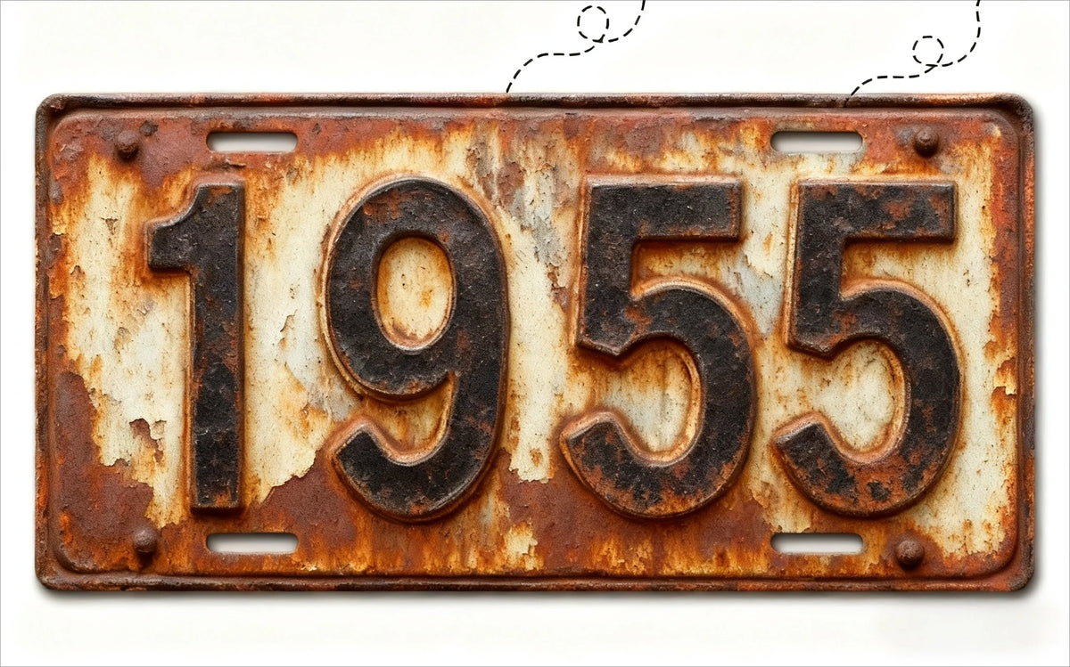 A vintage, rusted aluminum license plate tag with the year 1955 embossed on it.