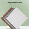 A stack of white and gray foam brick wallpaper panels displayed on a round green pedestal.