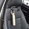 A car headrest hook with a metal carabiner is attached to the seat for bag storage.