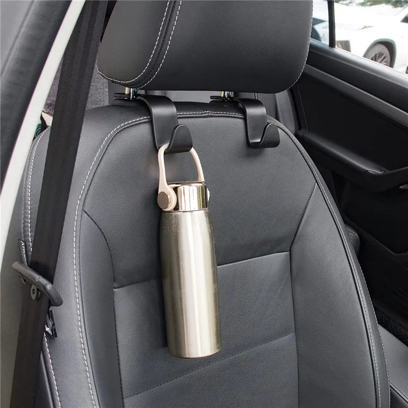 A car headrest hook with a metal carabiner is attached to the seat for bag storage.