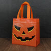 Orange Halloween party treat bags featuring a carved pumpkin face design