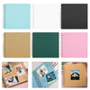 A collection of various colored spiral-bound notebooks and scrapbook albums shown side by side.