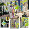 A set of seven crystal prism sun catchers hanging from a tree branch against a blurred green background.