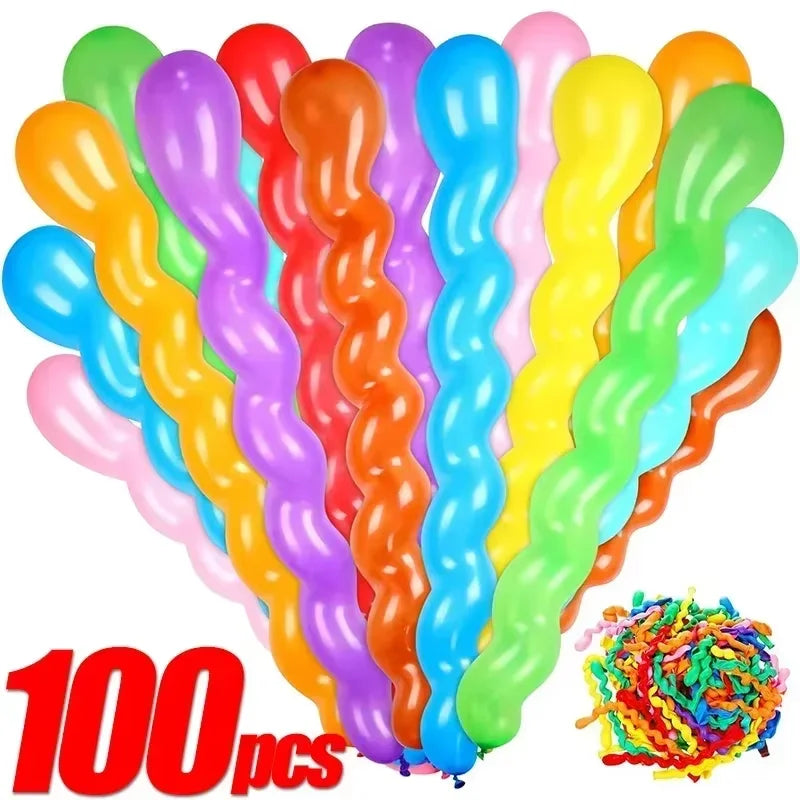 A bunch of colorful spiral latex party balloons in various shades including pink, purple, orange, and green.