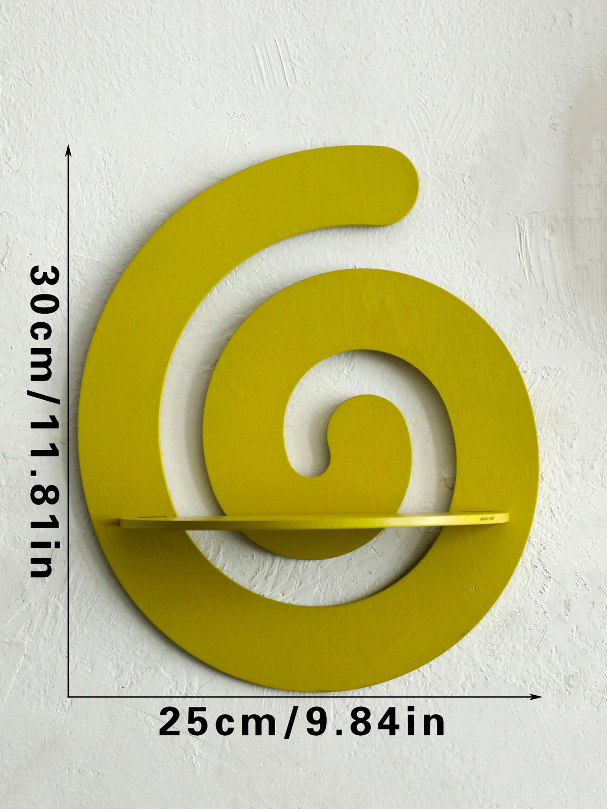 A bright yellow, cherry-shaped wooden wall shelf with a spiral design mounted on a white wall.