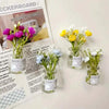 A collection of small glass jars filled with fresh flowers and labeled Good Luck