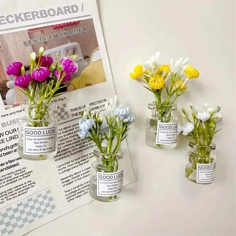 A collection of small glass jars filled with fresh flowers and labeled Good Luck