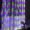 Purple and green LED curtain fairy lights illuminating a sheer fabric backdrop.