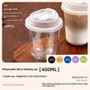 A set of ten clear disposable coffee cups with lids is shown on a wooden surface.