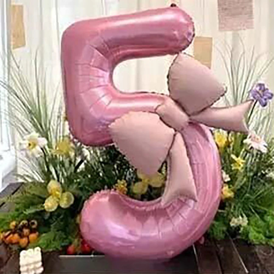 Pink 32-inch number balloons shaped like the number 9 with matte bow decor