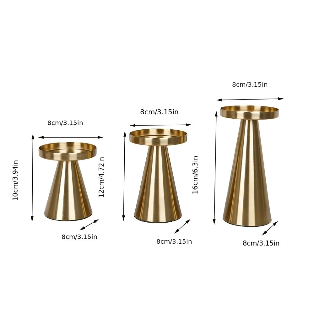 A set of three elegant gold metal candle holders with varying heights and tapered designs.