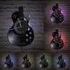 A collection of vintage vinyl record guitar wall clocks displayed on a brick wall.