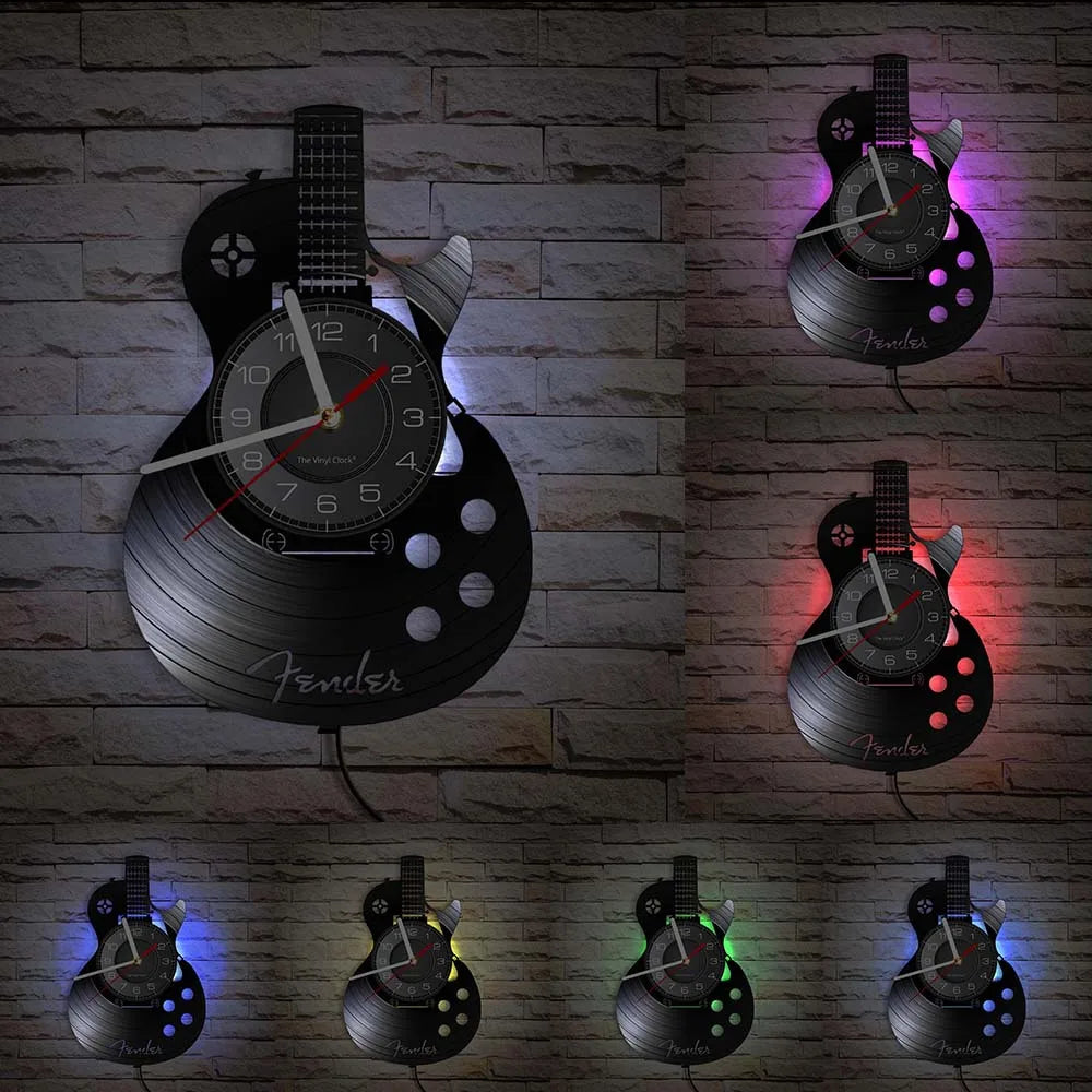 A collection of vintage vinyl record guitar wall clocks displayed on a brick wall.