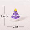A small purple and white resin Christmas tree charm with a yellow star topper.