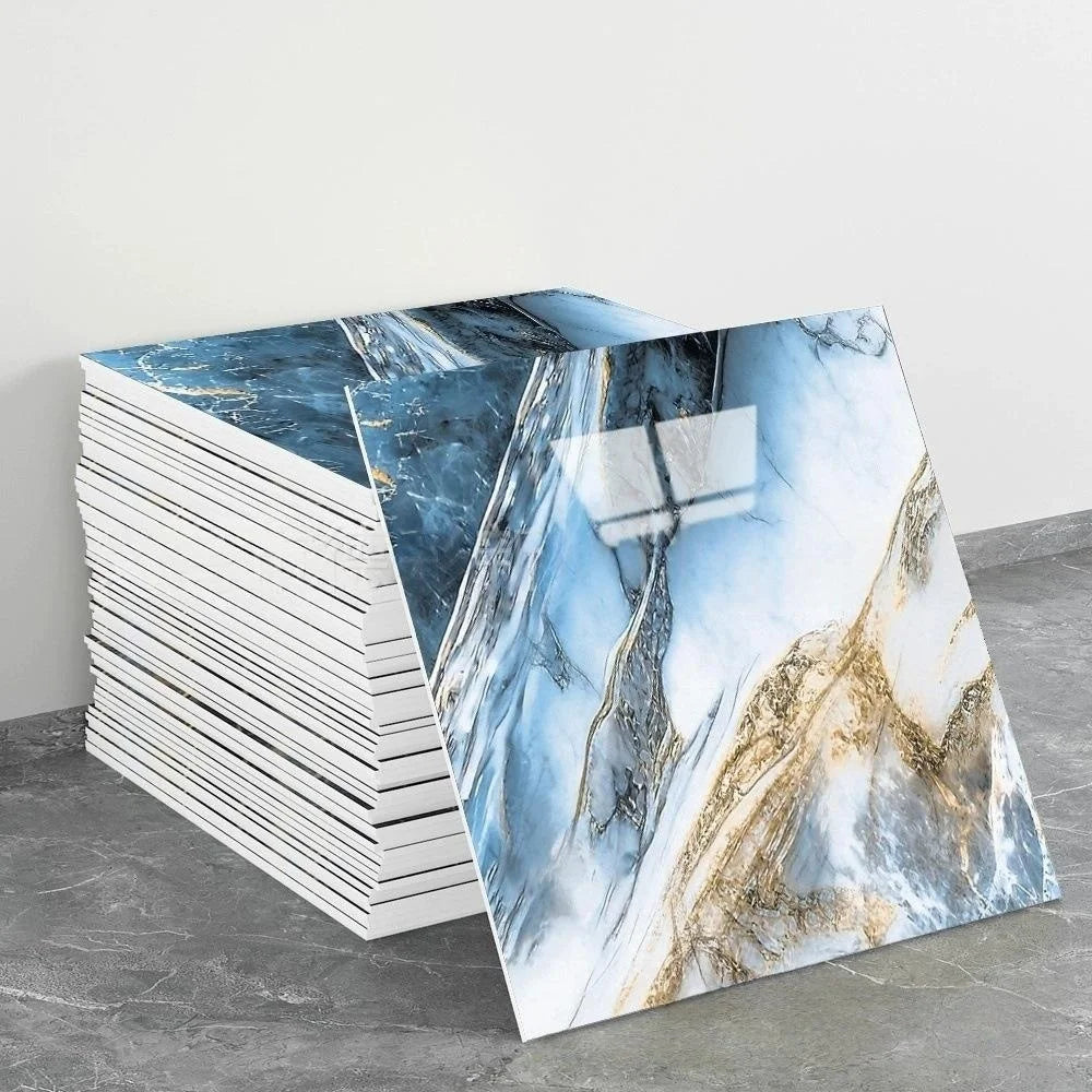 A stack of self-adhesive marble tile stickers featuring blue and gold veining on a gray background.