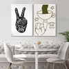 Un set de dos impresiones en lienzo pintadas a mano en blanco y negro con símbolos de paz y amor y un diseño de taza de café.