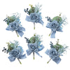 A set of six dusty blue silk rose boutonnières featuring blue flowers and green foliage.