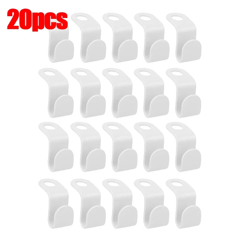 A set of 30 white space-saving hanger connector hooks for organizing and hanging items.