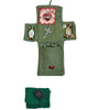 Handmade prayer quilt featuring a green fabric with silver cross and other decorative elements.
