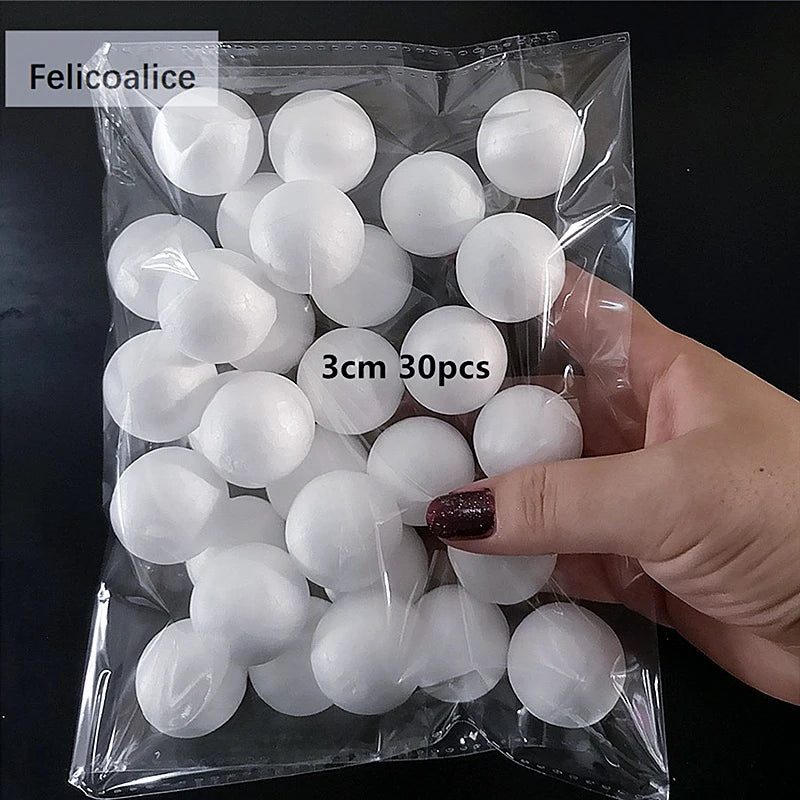 A hand holds a clear plastic bag filled with white polystyrene foam balls for crafting and decorating.