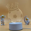 A glowing wireframe football crown night light displayed on a white base with a small astronaut figure.