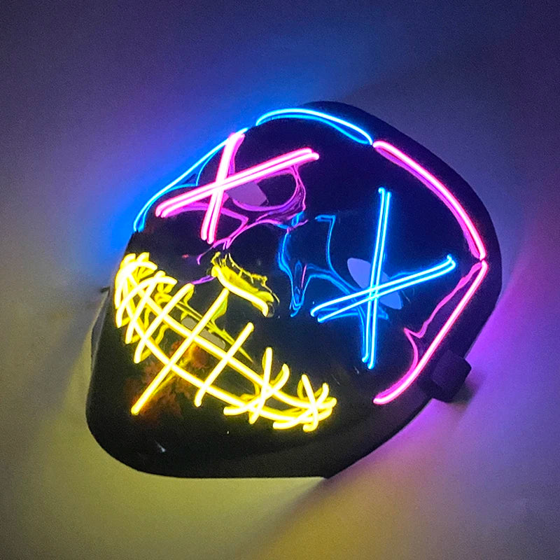 A black mask with neon pink and blue LED lines glowing on a wall.