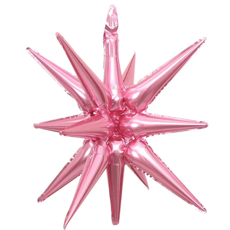 A cluster of pink star burst foil balloons used for party decor.