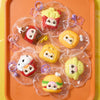 A collection of colorful, themed squeeze toys in clear plastic bags displayed on an orange tray.