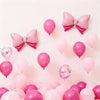 A collection of pink foil bow balloons in various shades of pink and magenta against a white background.
