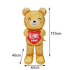 A golden teddy bear balloon with a red heart saying Love you on it.