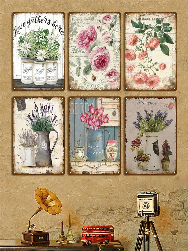A collection of vintage metal signs featuring floral designs and botanical illustrations.