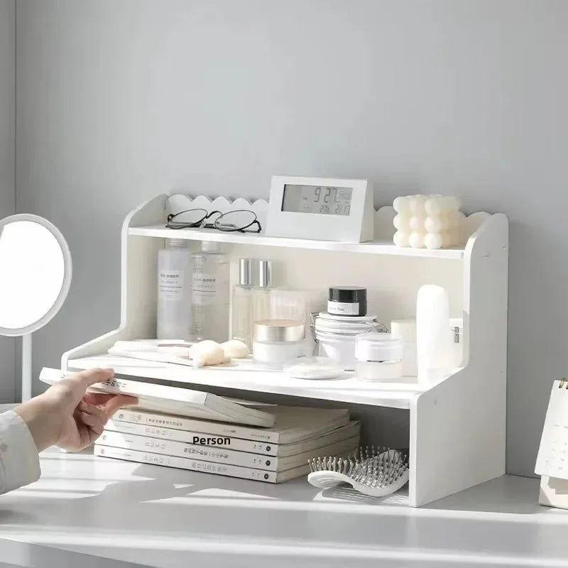 A white two-layer desktop organizer shelf displaying various skincare and beauty products.